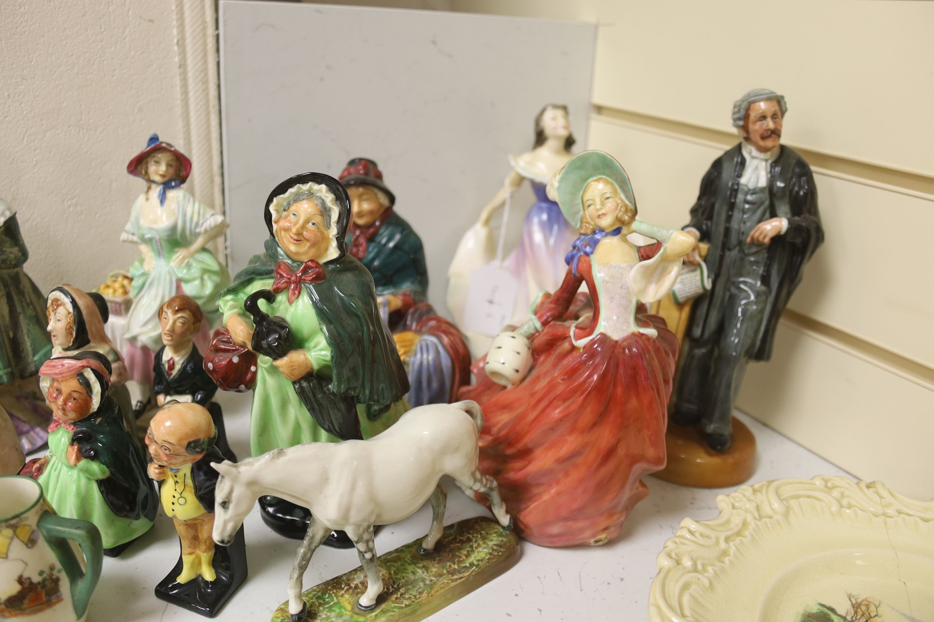 A group of 12 Royal Doulton figures and four plates